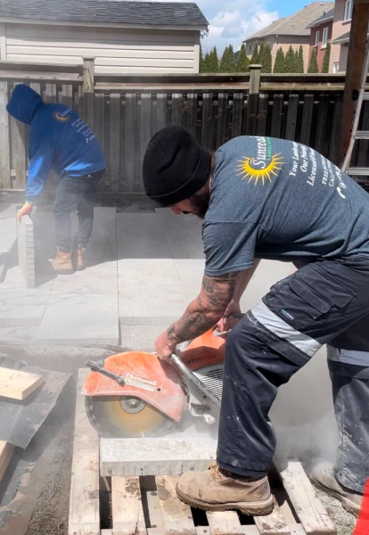 sunready landscaping man operates a concrete saw