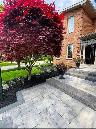 sunready landscaping stone patio adorned with a vibrant red tree